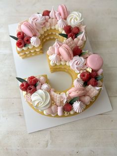 a cake shaped like the letter c with flowers and icing on it sitting on top of a white card