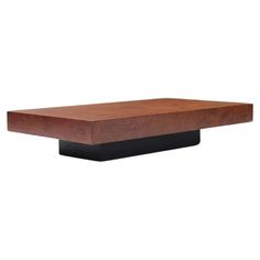 a square wooden table with black metal base