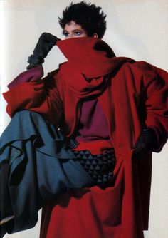 a woman in a red coat and black gloves