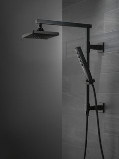 a shower head with thermostaer and hand held shower faucet in black and white