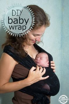 a woman holding a baby wrapped in a black wrap with the words diy baby wrap on it