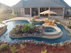 a backyard with a pool and patio furniture in the middle, surrounded by landscaping items