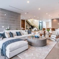 a living room filled with furniture and lots of windows