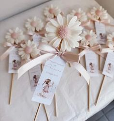 there are flowers on sticks with tags attached to them