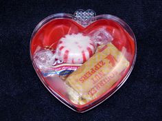 a heart shaped box filled with assorted candy