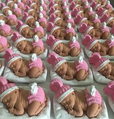 there are many small baby dolls in the shape of babies wearing hats and diapers