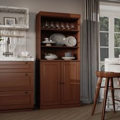 a dining room table and chairs in front of a wooden cabinet with dishes on it