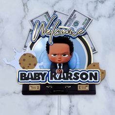 a sign that says welcome to baby kruson on top of a marble surface