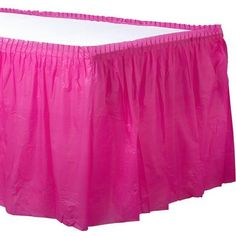 a pink bed skirt with pleated edges