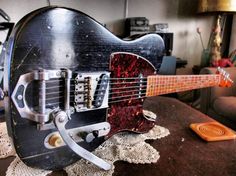 an electric guitar sitting on top of a table