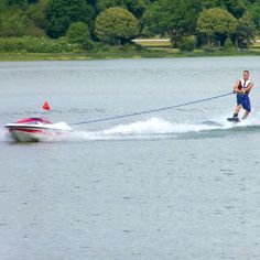 a man on water skis being pulled by a boat with a rope attached to it