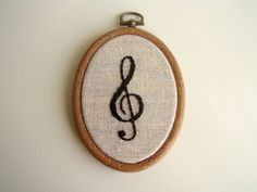 an embroidered musical note hanging on a wall