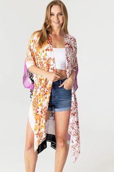 Boho print kimono with contrasting prints. Ultra light, draping open-front. Light and billowy silhouette, perfect for effortless layering. CARE | Hand Wash Cold or Dry Clean CONTENTS | 100% Viscose MEASUREMENTS | 36"/91 cm Top to Bottom (Size O/S) MODEL | 5'8 - wearing O/S IMPORTED Orange Open Front Kimono For The Beach, White V-neck Kimono For Day Out, Multicolor Print Kimono For Spring Beach Cover-up, Casual White Printed Kimono, Casual Printed White Kimono, White Floral Print Wrap Kimono, White Flowy Kimono With Floral Print, White Flowy Kimono With Kimono Sleeves, Multicolor V-neck Kimono For Day Out