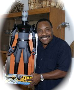 a man is holding up a star wars action figure