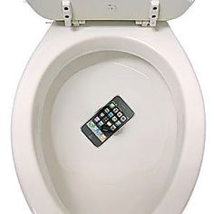 a cell phone sitting in the middle of a toilet bowl with its lid open and seat up