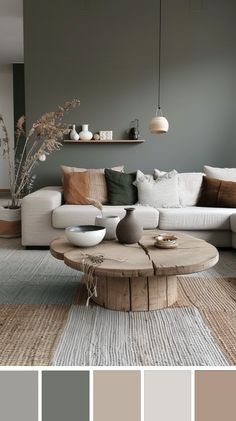 a living room with grey walls and white couches, coffee table and rugs