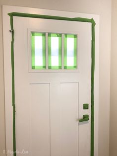 a white door with green tape on it