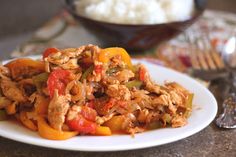 a white plate topped with meat and vegetables