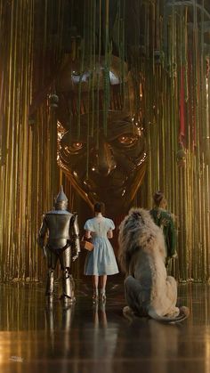 the wizard and the person are standing in front of a giant mask with bamboo stalks hanging from it