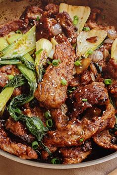 a bowl filled with meat and vegetables on top of a table