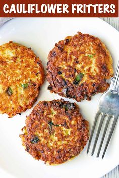 three fritters on a white plate with a fork next to one and another