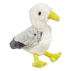 a stuffed bird sitting on top of a white surface