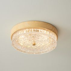 a wooden light fixture hanging from the ceiling