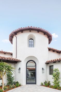 a large white house with an arched doorway