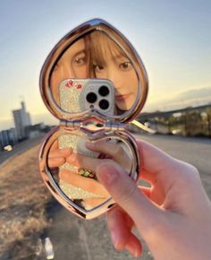 a person taking a selfie in a mirror with their cell phone up to their face