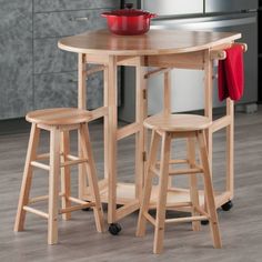 a kitchen table with two stools next to it