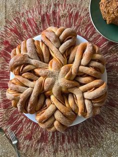 a white plate topped with lots of doughnuts next to a bowl of cookies