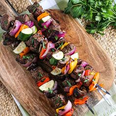 skewered meat and vegetables on a cutting board