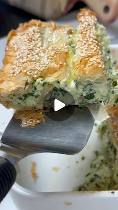 a piece of broccoli and cheese quiche being lifted from a casserole dish