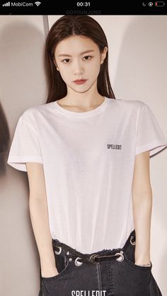 a young woman wearing a white shirt and black skirt with the words spell out on it