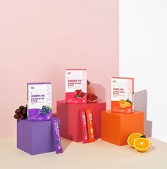 three boxes with different types of fruit on top of each box, one orange and one grapefruit