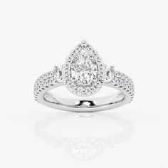 a pear shaped diamond engagement ring on a white background