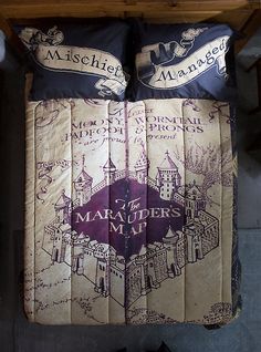 the bed is made up with harry potter themed sheets and pillow cases on top of it