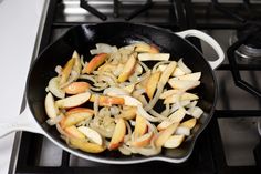 onions and apples cooking in a skillet on the stove