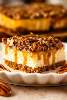 a slice of cheesecake with pecans on the side