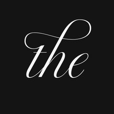 the word'the'written in cursive font on a black background with white ink