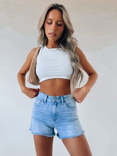 DETAILS:   Our Joanie Denim shorts are the perfect highrise lightwash denim shorts for summer. These shorts are a classic high rise denim shorts with a frayed hemline and functional pocket detail.  11" RISE, 4.5" INSEAM, 12"  CONTENT & CARE:   SELF: 95% Cotton, 4 Elasterell, 1% spandex   SIZE & FIT: Model is 5' Cropped White Tee, Shorts For Summer, High Rise Denim Shorts, High Rise Denim, Light Denim, Pocket Detail, Summer Shorts, Cropped Tank Top