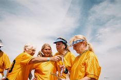 a group of people in yellow shirts standing next to each other