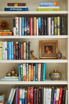 a bookshelf filled with lots of different colored books