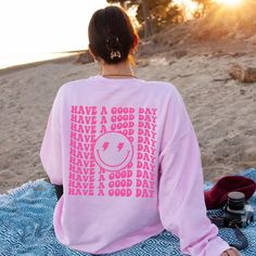 This preppy smile face sweatshirt will be your newest obsession! If you love the vibe and aesthetic of oversized crewnecks then this trendy y2k sweatshirt is perfect for you or makes the cutest gift for teen girls or sorority sisters. ✦ Gildan brand ✦ Unisex Adult Sizing ✦ 50% Cotton/50% Polyester ✦ DTG (Direct To Garment) printing where the ink is printed directly into the fabric. ✦ Mockups are used for demonstration purposes only. The design is printed directly on the garment and the final pro Oversized Graphic Print Sweatshirt For Weekend, Cute Oversized Slogan Sweatshirt, Trendy Slogan Sweatshirt For Leisure, Trendy Smiley Face Tops For Loungewear, Trendy Smiley Face Loungewear Tops, Trendy Oversized Smiley Face Top, Trendy Long Sleeve Sweatshirt With Smiley Face, Fun Oversized Sweatshirt For Loungewear, Trendy Funny Print Sweatshirt For Loungewear