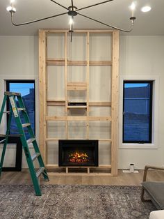 a living room with a fire place and ladder