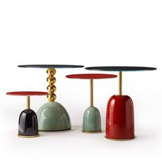 three tables with different colored tops on each one, and gold bases in the middle