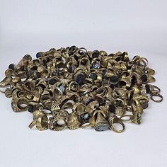 a pile of antique brass bells on a white background