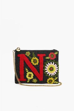 N embellished hand beaded crossbody clutch offers versatility with its adjustable crossbody strap, enabling you to wear it as a shoulder bag or crossbody for hands-free convenience. The strap can be easily detached, giving you the option to carry it as a classic clutch - perfect for both day and night occasions. Top Zip Clutch Embroidery in Front with Letter N Lined Interiors Detachable Chain Strap Top Zip Closure Size: 10" X 7.5" Handmade by artisans in India Chic Beaded Crossbody Shoulder Bag, Spring Crossbody Clutch With Adjustable Strap, Trendy Beaded Crossbody Shoulder Bag, Beaded Crossbody Clutch, Everyday Beaded Crossbody Shoulder Bag, Everyday Beaded Crossbody Clutch, Beaded Crossbody Shoulder Bag For Travel, Spring Crossbody Shoulder Bag With Zipper Pouch, Clutch Embroidery