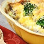 a casserole dish with broccoli and cheese in it on a table