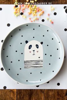 a plate with a panda face on it and sprinkles in the background